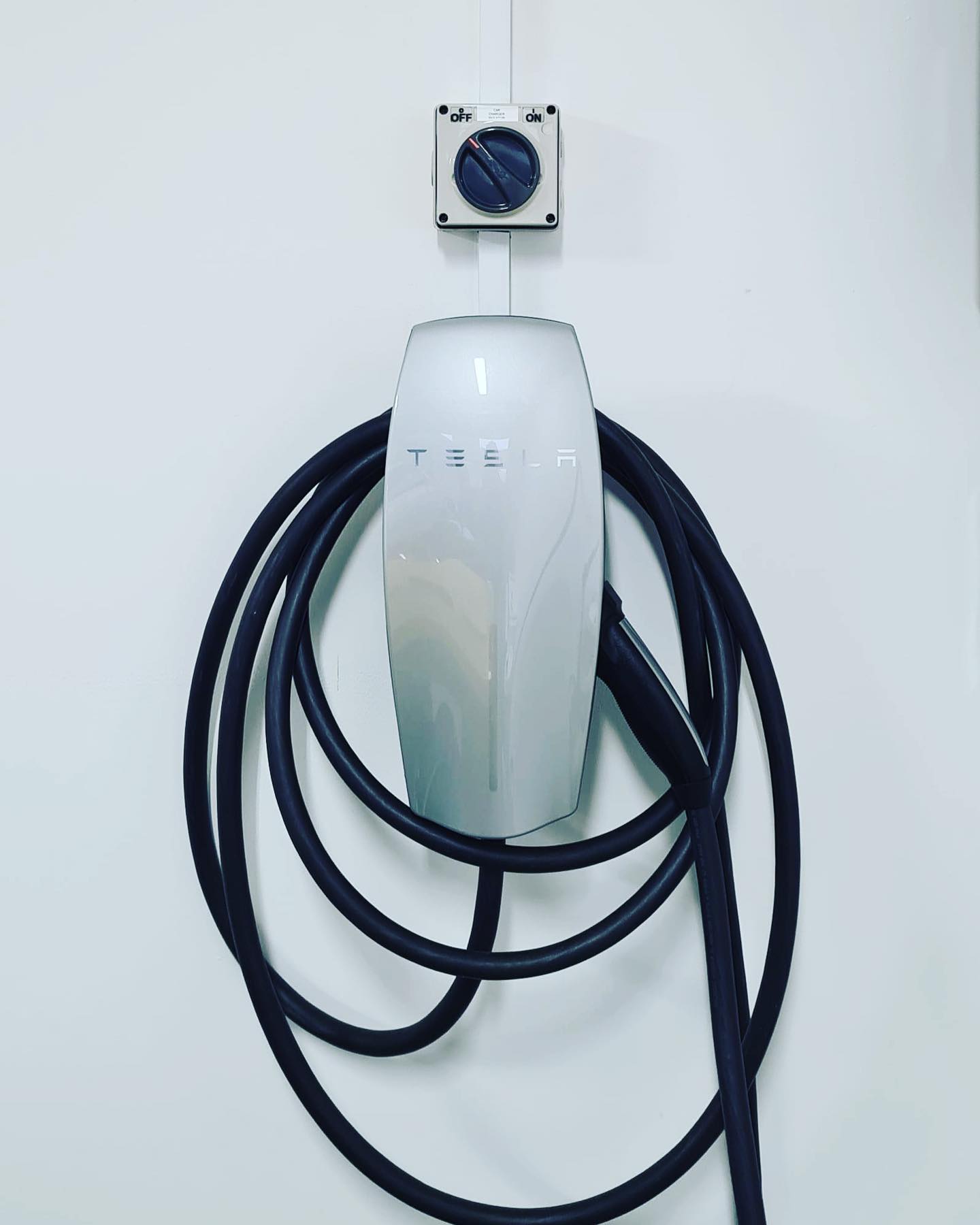 Tesla Wall Connector with isolator switch — clean garage install