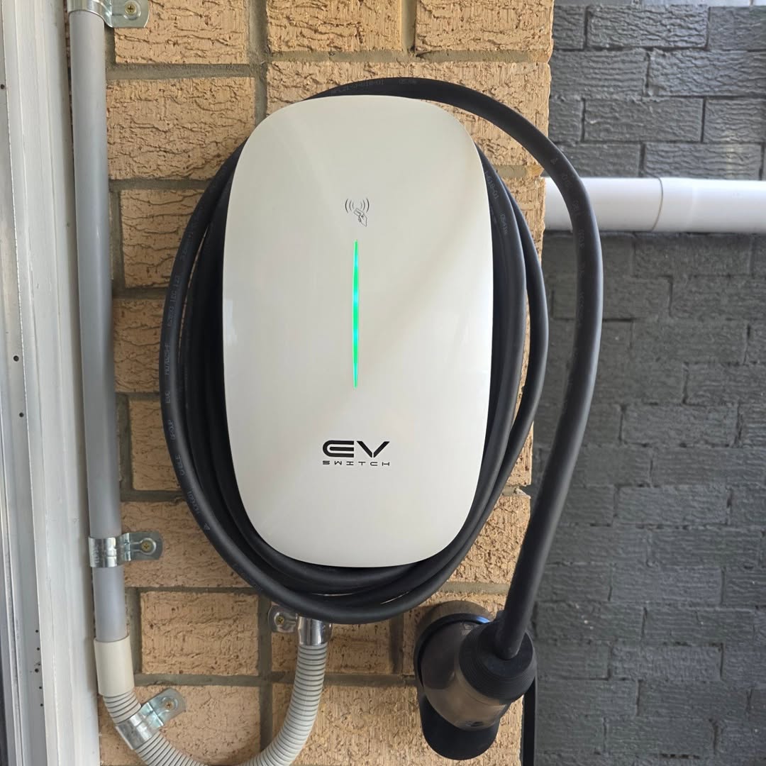 EV Switch charger on brick wall — Brisbane garage install