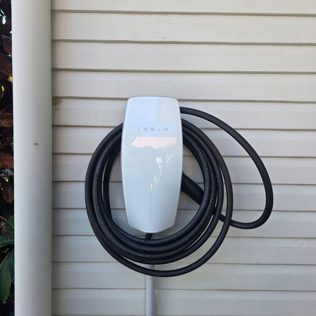 Tesla Wall Connector installed outdoors on weatherboard home — Brisbane